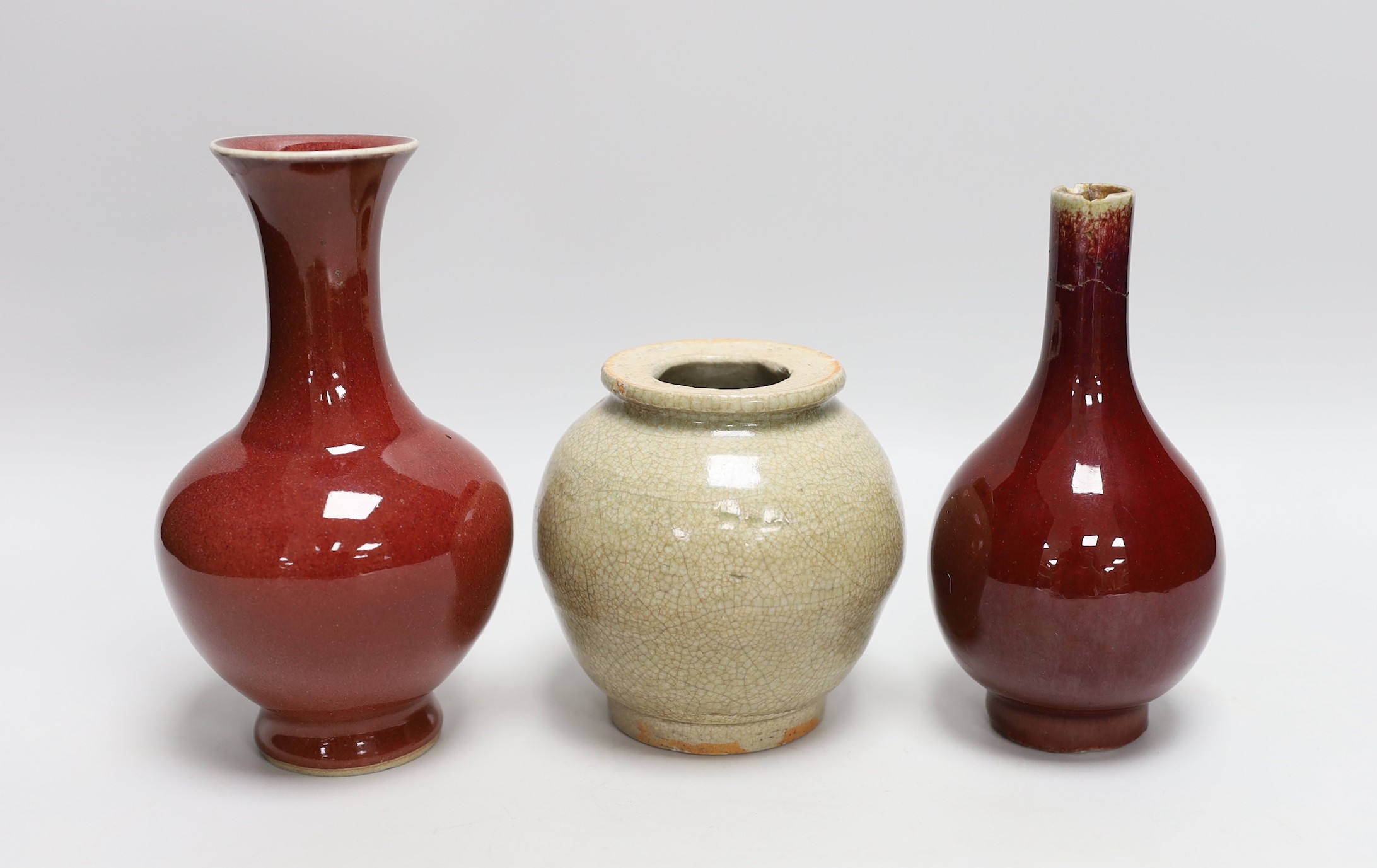 Two Chinese sang de boeuf vases and a crackle glaze jar, tallest 17cm